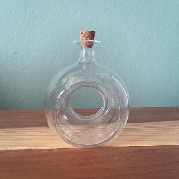 Glass round bottle with a hole